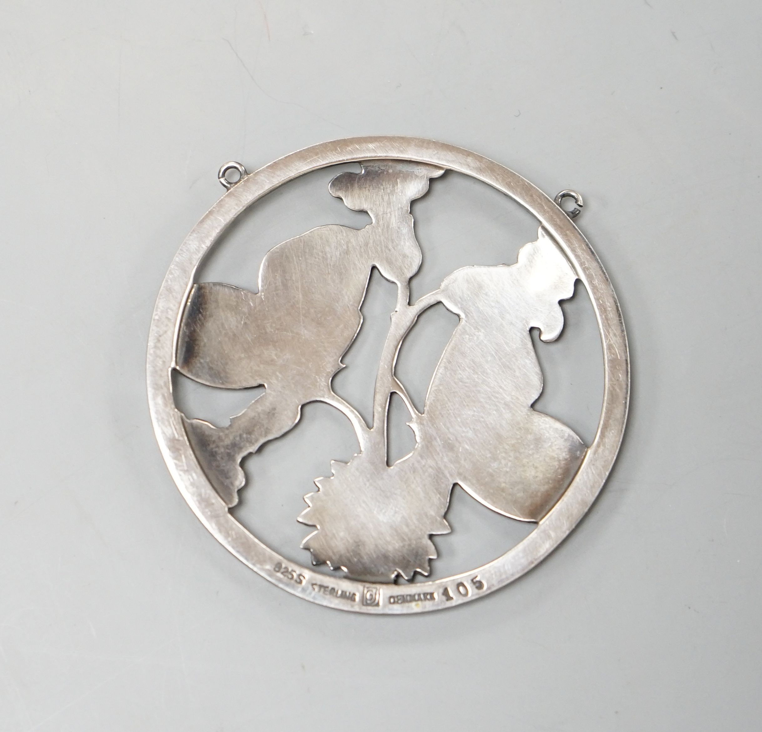 A Georg Jensen sterling circular 'two butterflies on flower' pendant, designed by Arno Malinowski, no. 105, 52mm.